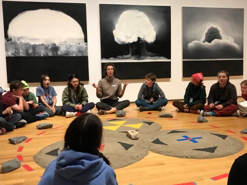 BCK students sitting in a circle engaged in listening to an expert