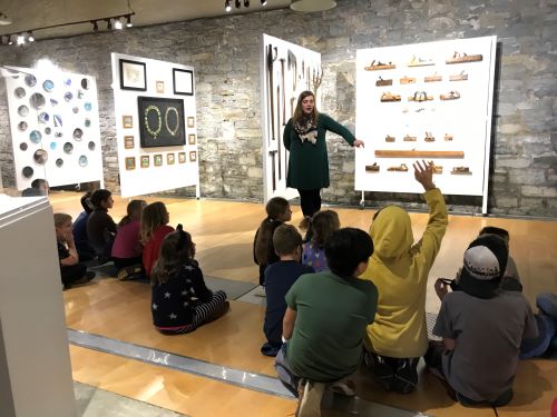 BCK students listening to expert about historical artifacts at the Museum of Lennox and Addington.