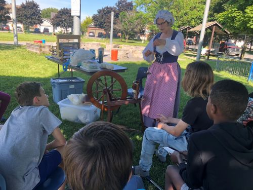 BCK students watching an expert spin wool.